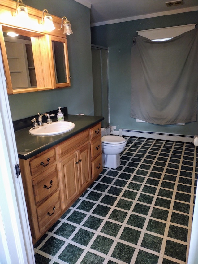 bathroom with crown molding, vanity, and toilet