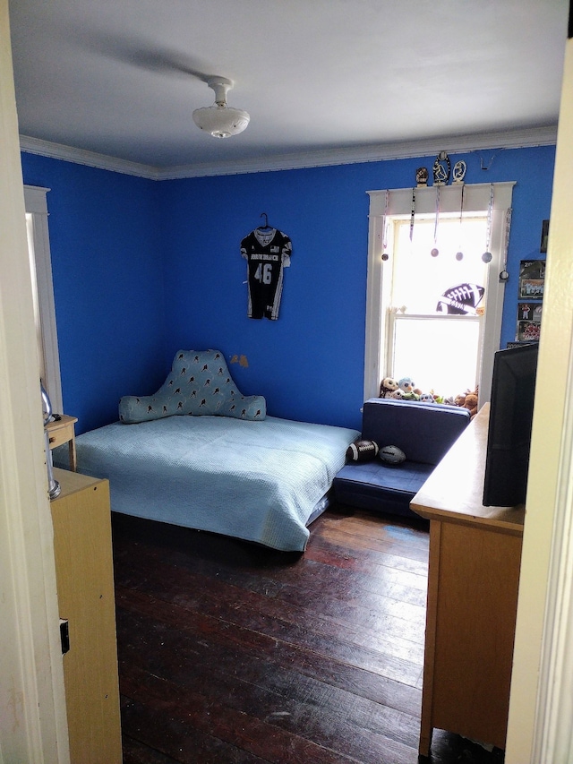 bedroom featuring hardwood / wood-style flooring and crown molding