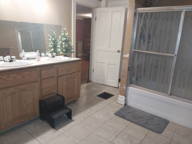 bathroom with tile patterned flooring, vanity, and enclosed tub / shower combo