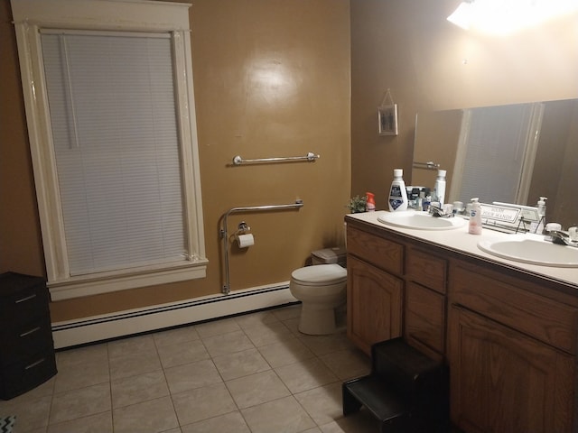 bathroom featuring baseboard heating, tile patterned flooring, vanity, and toilet