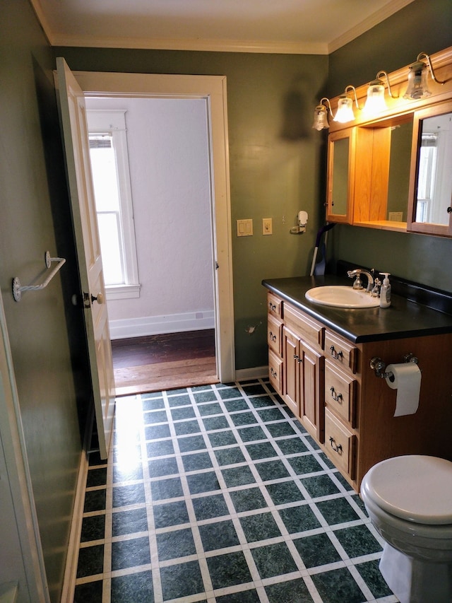 bathroom featuring hardwood / wood-style flooring, vanity, toilet, and crown molding