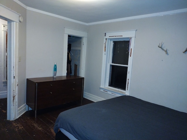 bedroom with dark hardwood / wood-style floors and crown molding