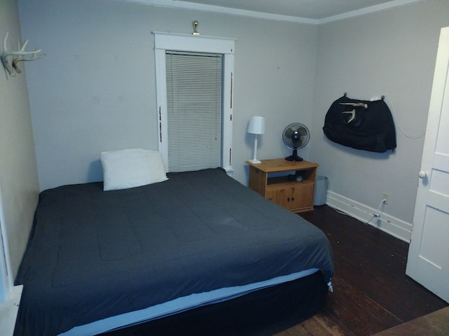 bedroom featuring dark hardwood / wood-style floors and ornamental molding