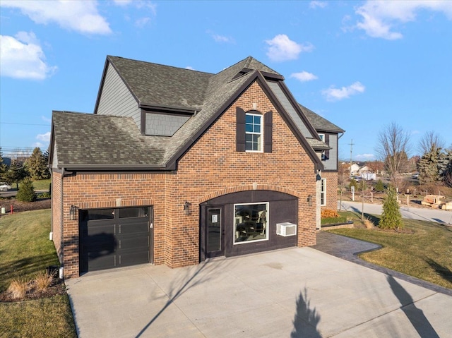 view of front of property featuring a garage and a front lawn