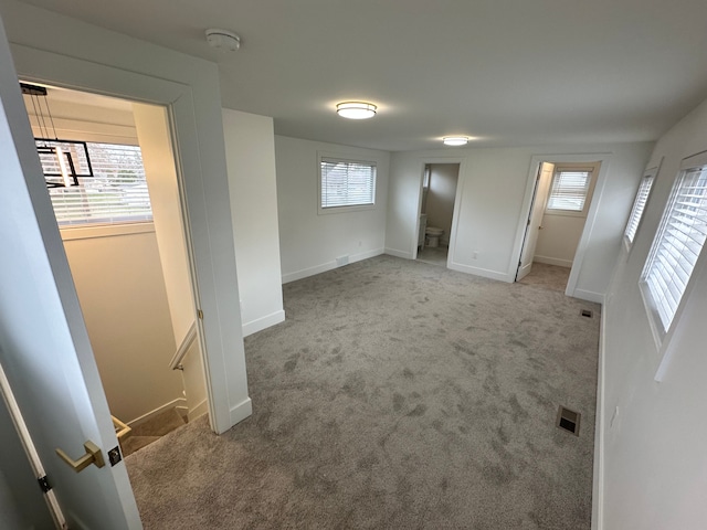 empty room featuring a healthy amount of sunlight and carpet