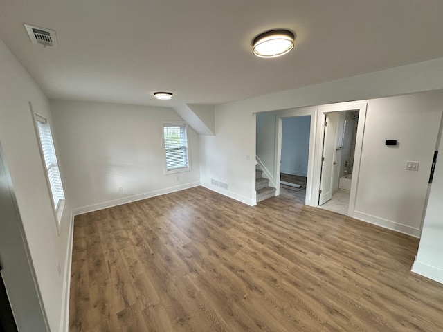 unfurnished room with wood-type flooring