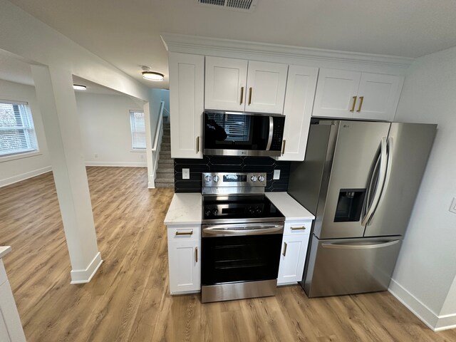 kitchen featuring white cabinetry, a wealth of natural light, and appliances with stainless steel finishes