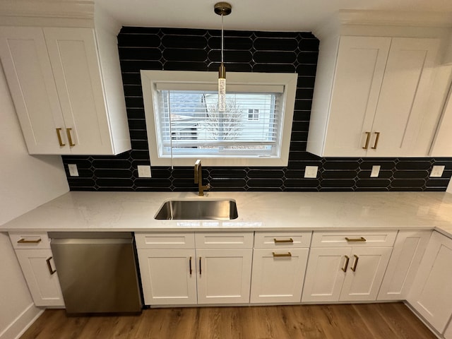 kitchen with sink, hardwood / wood-style flooring, dishwasher, white cabinets, and decorative light fixtures