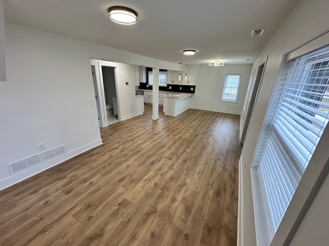 unfurnished living room with hardwood / wood-style floors