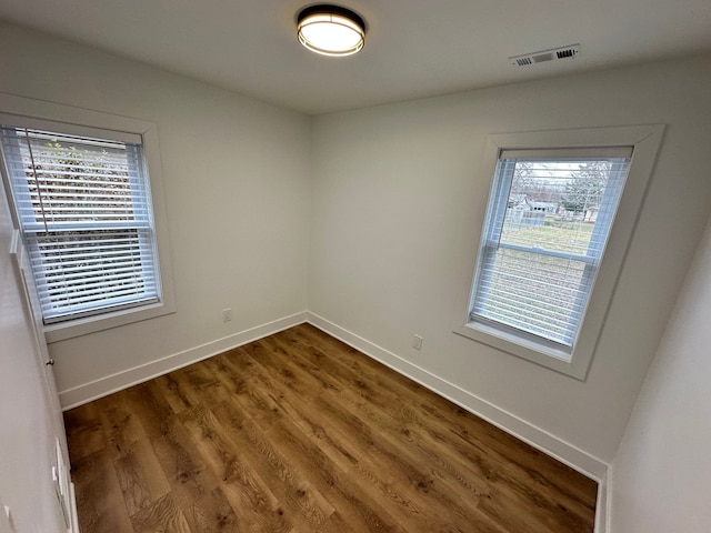 spare room featuring dark hardwood / wood-style floors