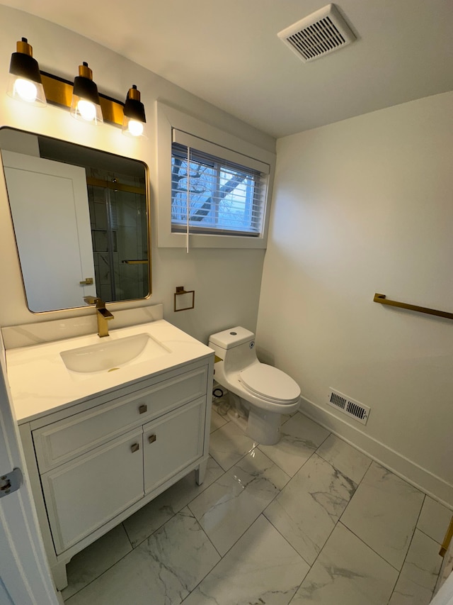 bathroom with vanity, an enclosed shower, and toilet