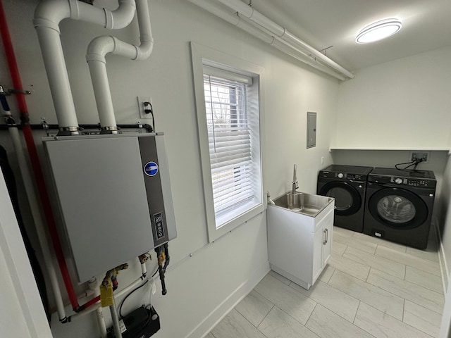 clothes washing area featuring sink, cabinets, washer and dryer, electric panel, and water heater