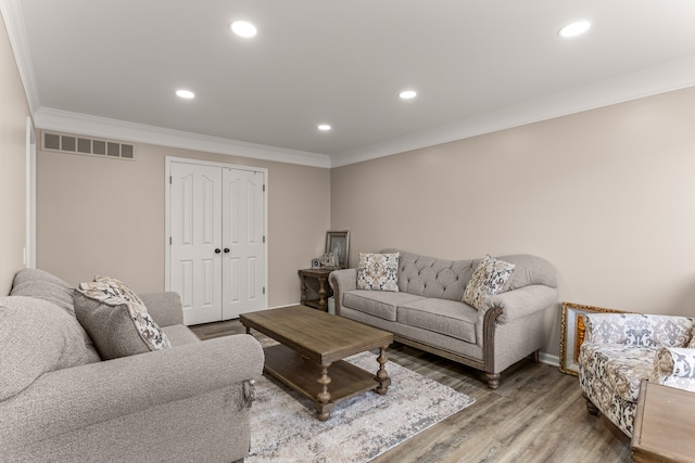 living room featuring wood-type flooring and ornamental molding