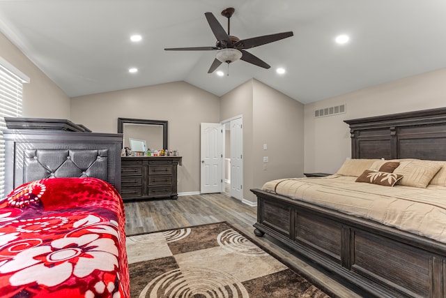 bedroom with ceiling fan, wood-type flooring, and vaulted ceiling