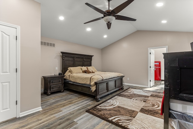 bedroom featuring ceiling fan, wood-type flooring, and lofted ceiling