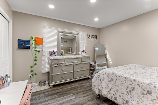 bedroom with dark hardwood / wood-style floors