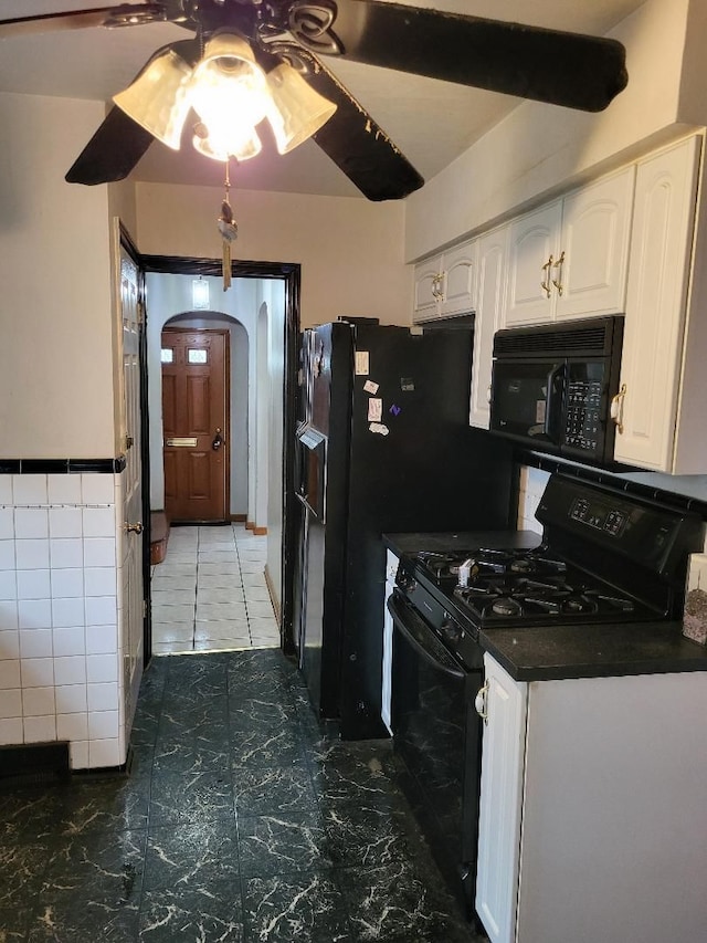 kitchen with white cabinetry, ceiling fan, and black appliances