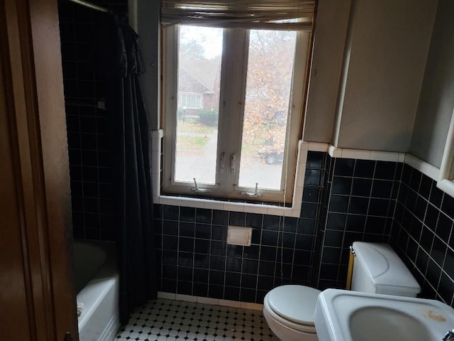 full bathroom featuring tile patterned flooring, shower / bathing tub combination, toilet, and tile walls