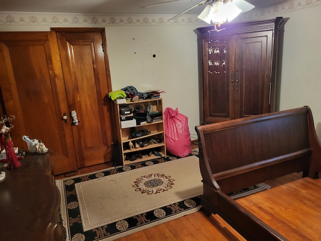 bedroom with hardwood / wood-style floors and ceiling fan