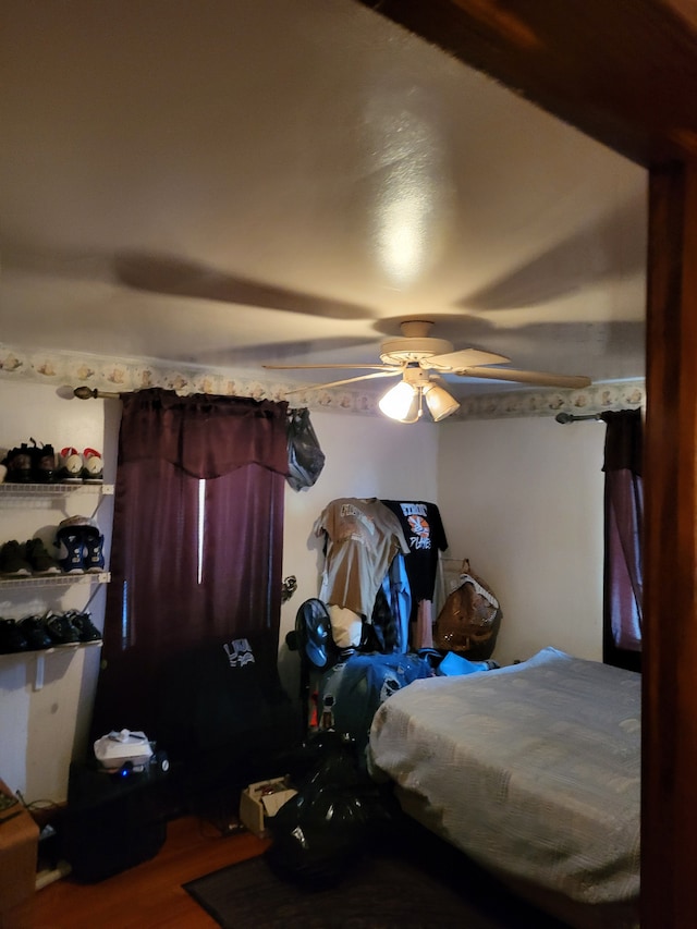 bedroom with ceiling fan and wood-type flooring