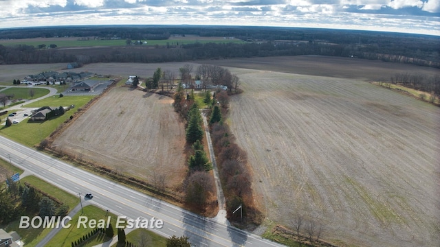 birds eye view of property with a rural view