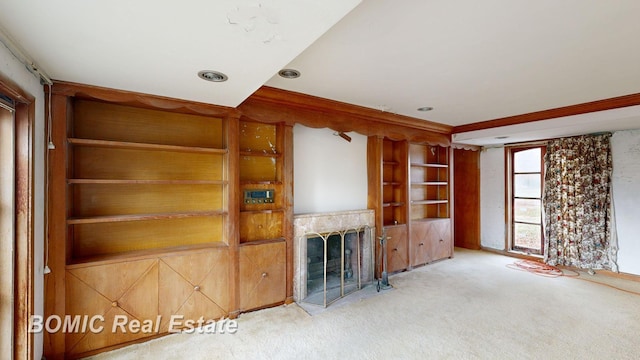 unfurnished living room with carpet flooring and ornamental molding