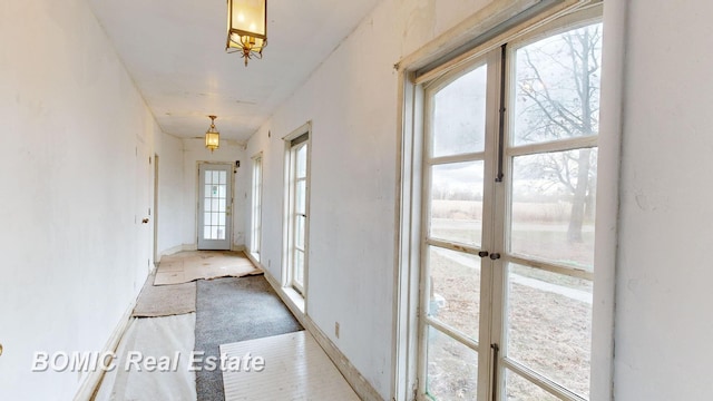 hallway featuring a wealth of natural light and french doors