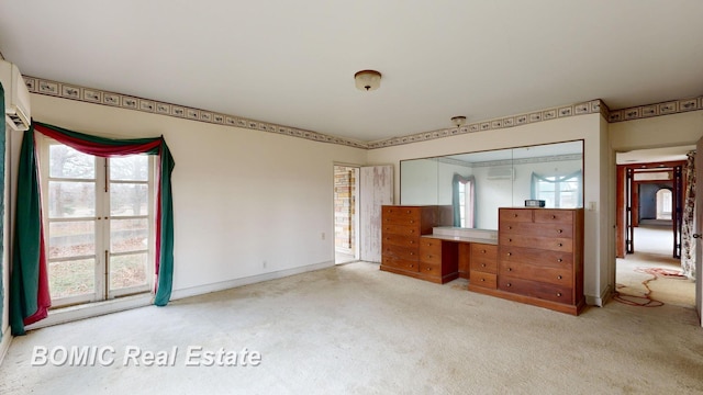 unfurnished bedroom featuring light colored carpet and a closet