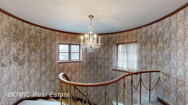 unfurnished dining area featuring crown molding, a wealth of natural light, and an inviting chandelier