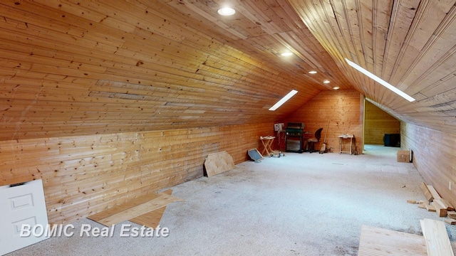 additional living space featuring carpet, lofted ceiling, wood walls, and wood ceiling