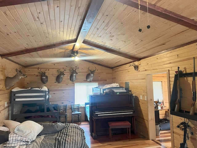 interior space featuring wood ceiling, ceiling fan, hardwood / wood-style flooring, vaulted ceiling with beams, and wood walls