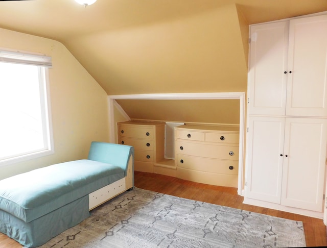 sitting room with vaulted ceiling and light hardwood / wood-style flooring