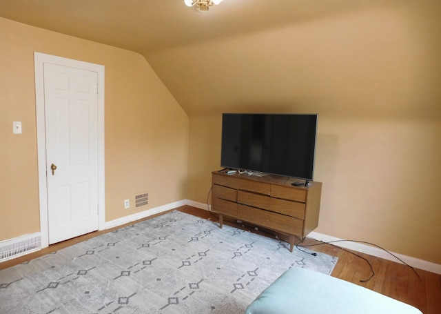 interior space featuring vaulted ceiling and light hardwood / wood-style floors