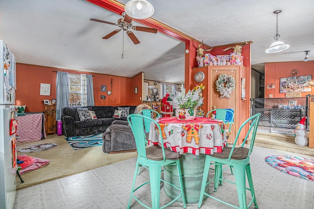 carpeted dining area featuring a textured ceiling and ceiling fan