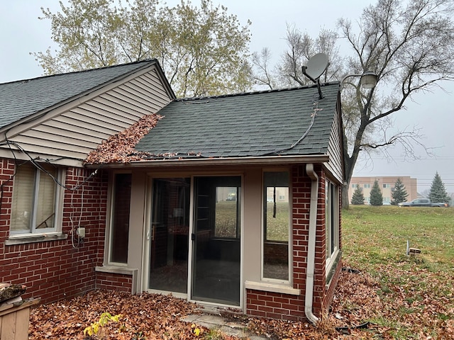 rear view of house featuring a yard