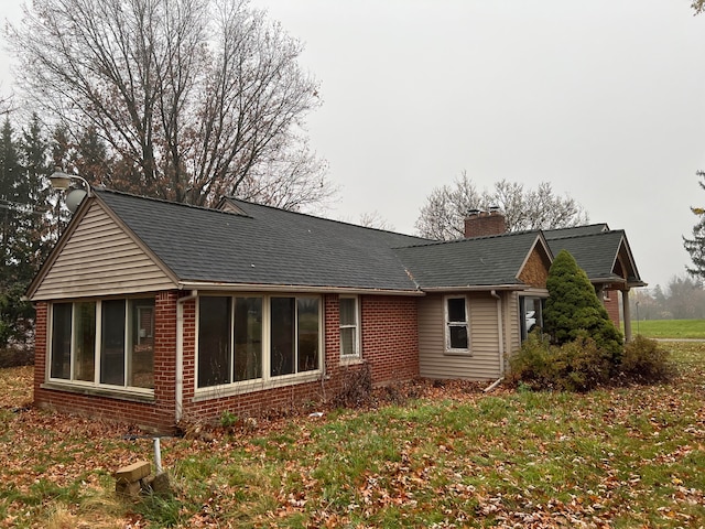 view of property exterior with a lawn