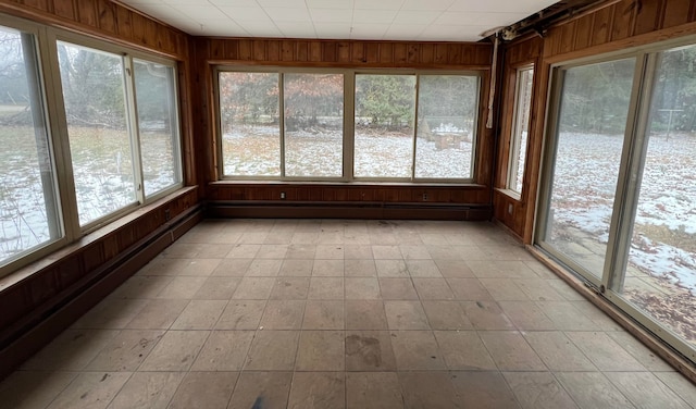 unfurnished sunroom featuring a baseboard radiator