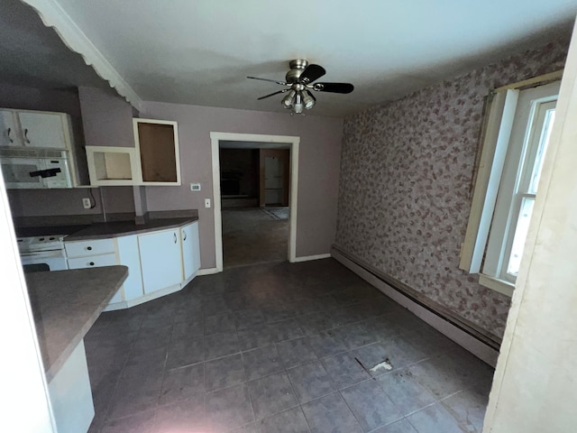 kitchen with baseboard heating, ceiling fan, white cabinets, and white appliances