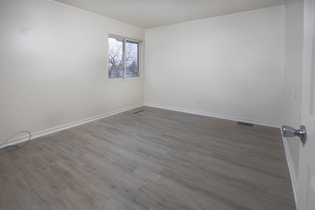 unfurnished room featuring hardwood / wood-style flooring and crown molding