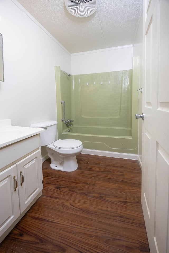 full bathroom with vanity, wood-type flooring, toilet, a textured ceiling, and shower / bath combination