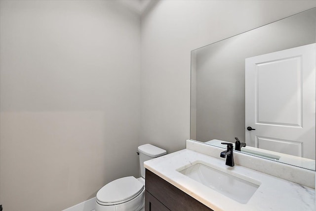 bathroom with toilet and vanity