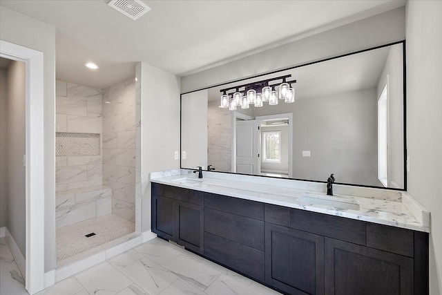 bathroom with vanity and a tile shower