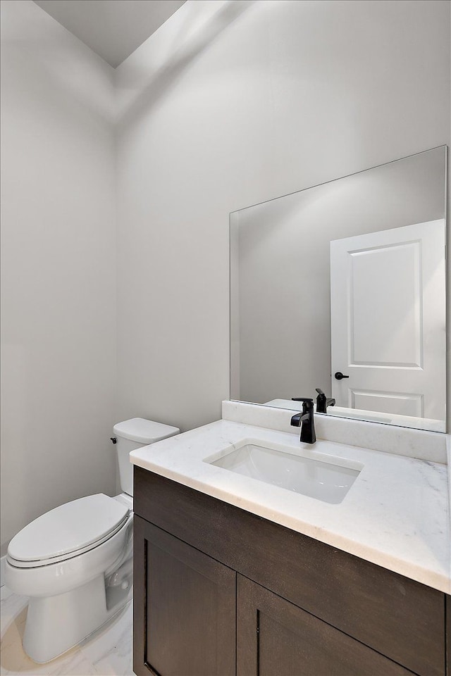 bathroom featuring toilet and vanity