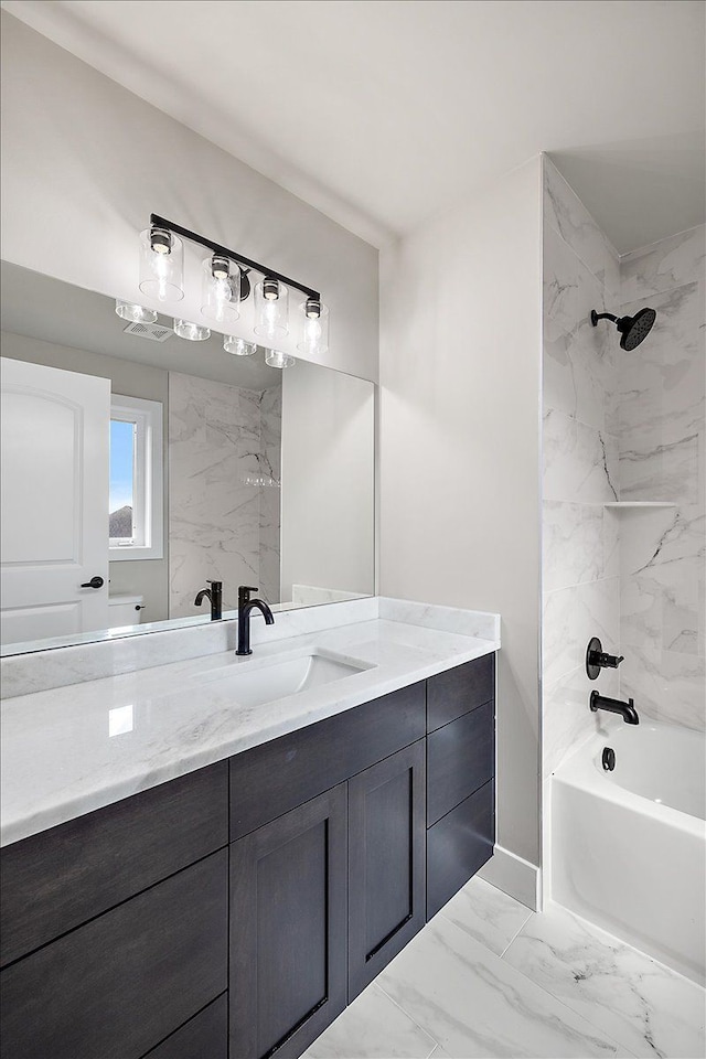 bathroom with tiled shower / bath combo and vanity