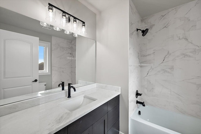 bathroom with vanity and tiled shower / bath