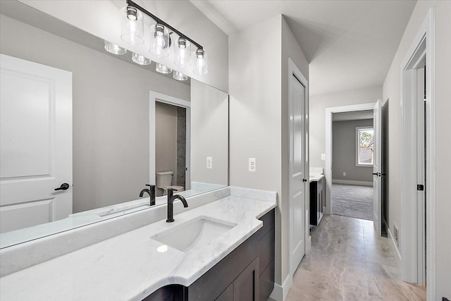 bathroom featuring toilet and vanity