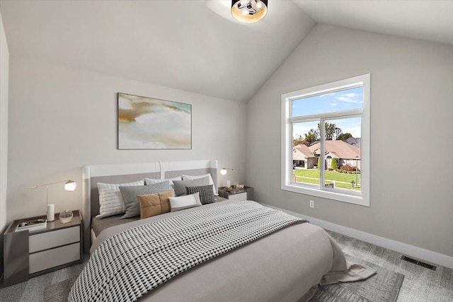 bedroom with lofted ceiling and carpet floors