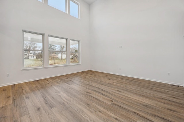 interior space with a high ceiling and light wood-type flooring