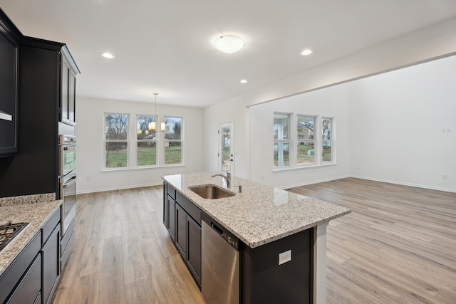 kitchen with sink, an island with sink, plenty of natural light, and appliances with stainless steel finishes