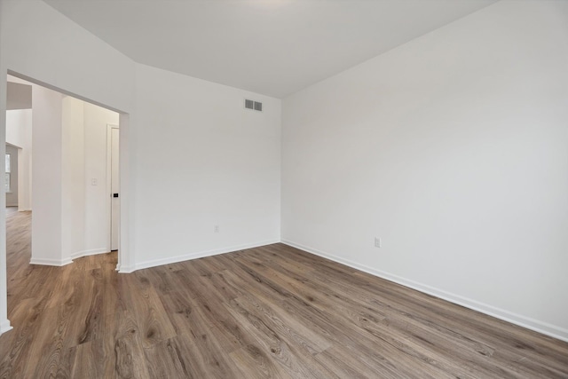 unfurnished room with hardwood / wood-style flooring